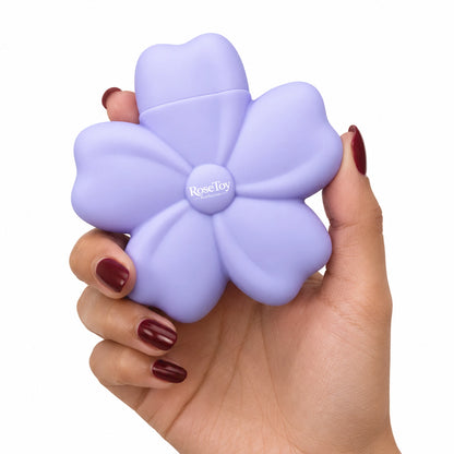 Purple Cherry Blossom vibrator held in hand to show its compact flower-shaped design